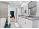 Bright bathroom featuring double vanity sinks, soaking tub, glass enclosed shower and an ensuite bedroom view at 310 S Habana Ave # 5, Tampa, FL 33609