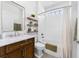 Bright bathroom features a single sink vanity, a shower over tub combo with white herringbone tile at 310 S Habana Ave # 5, Tampa, FL 33609