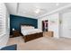 Spacious bedroom with a tray ceiling, dark wood furnishings, walk-in closet and stylish blue accent wall at 310 S Habana Ave # 5, Tampa, FL 33609