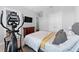 This bedroom includes an elliptical machine for exercising, double doors, and a queen sized bed at 310 S Habana Ave # 5, Tampa, FL 33609
