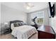 This bedroom features an exercise bike, neutral decor, lots of natural light, and a TV at 310 S Habana Ave # 5, Tampa, FL 33609