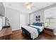 Cozy bedroom features a ceiling fan, two windows with shutters, and wood flooring at 310 S Habana Ave # 5, Tampa, FL 33609