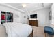 Bright bedroom featuring a walk-in closet, ensuite bathroom, dresser, and a comfortable sitting area at 310 S Habana Ave # 5, Tampa, FL 33609