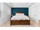 Comfortable bedroom featuring a tray ceiling, bedside tables, and a stylish blue accent wall at 310 S Habana Ave # 5, Tampa, FL 33609