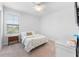 This bedroom features neutral carpet, a white ceiling fan, and a large window for natural light at 310 S Habana Ave # 5, Tampa, FL 33609