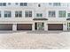 Charming townhome exterior features a brown garage door and light colored brick paver driveway at 310 S Habana Ave # 5, Tampa, FL 33609
