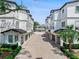 Elegant townhouses featuring a paved driveway, individual garages, and manicured landscaping at 310 S Habana Ave # 5, Tampa, FL 33609