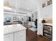 Open kitchen with living area has quartz counters, stainless appliances, beverage cooler, and white cabinets at 310 S Habana Ave # 5, Tampa, FL 33609