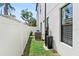 A practical side yard features a newer AC unit and water filtration system for the home at 310 S Habana Ave # 5, Tampa, FL 33609
