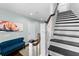 Elegant staircase with dark treads, white risers, a light blue wall with art and a blue settee at 310 S Habana Ave # 5, Tampa, FL 33609