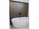 A modern white bathtub is set against a textured wall framed with a black border at 3125 Tucson Rd, North Port, FL 34286