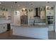 Modern kitchen featuring stainless steel appliances, a large island, and stylish pendant lighting at 3125 Tucson Rd, North Port, FL 34286