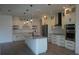 Spacious open-concept kitchen featuring a large island, wine storage, and stainless steel appliances at 3125 Tucson Rd, North Port, FL 34286