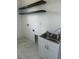 The laundry room features a stainless steel sink with white cabinets and black shelving at 3125 Tucson Rd, North Port, FL 34286
