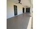 A covered patio with an epoxy floor and ceiling fans at 3125 Tucson Rd, North Port, FL 34286