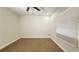 Vacant bedroom with neutral carpet, a ceiling fan, and bright natural light at 3145 Munson St, New Port Richey, FL 34655