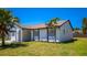 Exterior of the home featuring black trim and a large front yard at 3145 Munson St, New Port Richey, FL 34655