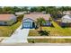 Charming single-story home with a palm tree in the front yard and a freshly painted driveway at 3145 Munson St, New Port Richey, FL 34655