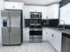 Modern kitchen features white cabinets, stainless steel appliances, and granite countertops at 3145 Munson St, New Port Richey, FL 34655