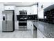 Modern kitchen features white cabinets, stainless steel appliances, and granite countertops at 3145 Munson St, New Port Richey, FL 34655