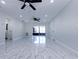 Spacious living area with modern marble floors, white walls, and ceiling fans for comfort at 3145 Munson St, New Port Richey, FL 34655