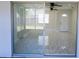 Bright living room with marble floors leads to a screened patio through sliding glass doors at 3145 Munson St, New Port Richey, FL 34655