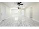 Bright and airy living room featuring elegant marble floors and modern ceiling fans at 3145 Munson St, New Port Richey, FL 34655