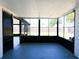 A sunroom with black screened walls, windows, and concrete floors at 3145 Munson St, New Port Richey, FL 34655