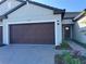 Charming home exterior with a brick driveway, two-car garage, and a welcoming front door at 32024 Griffin Sands Ln, San Antonio, FL 33576