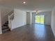 Bright living room with tile floors, a ceiling fan, and sliding glass doors to the outside at 32024 Griffin Sands Ln, San Antonio, FL 33576