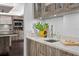 Stylish bar featuring granite countertops, custom wood cabinetry, and modern appliances at 3301 Bayshore Blvd # 2207B, Tampa, FL 33629