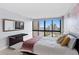 Cozy bedroom featuring a comfortable bed, a large window with beautiful waterfront views, and a modern desk at 3301 Bayshore Blvd # 2207B, Tampa, FL 33629
