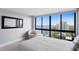Lovely bedroom featuring a chair, an ottoman, and amazing city views from the expansive windows at 3301 Bayshore Blvd # 2207B, Tampa, FL 33629