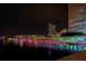 Night view of the city skyline with a bridge featuring colorful lighting reflecting on the bay at 3301 Bayshore Blvd # 2207B, Tampa, FL 33629