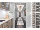 Hallway displaying a bar featuring wood cabinets, granite countertop and display wine cellar at 3301 Bayshore Blvd # 2207B, Tampa, FL 33629