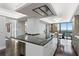 Bright kitchen boasts a large island with a cooktop, storage, and stylish lighting above at 3301 Bayshore Blvd # 2207B, Tampa, FL 33629