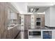 Gourmet kitchen featuring stainless steel appliances, marble countertops, custom cabinets, and hardwood floors at 3301 Bayshore Blvd # 2207B, Tampa, FL 33629