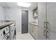 Bright laundry room with modern cabinets, granite counters, stainless steel appliances, and stylish tile flooring at 3301 Bayshore Blvd # 2207B, Tampa, FL 33629