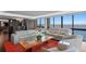 Living room with large water view windows and modern furniture at 3301 Bayshore Blvd # 2207B, Tampa, FL 33629
