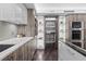 Well-organized pantry featuring custom wood cabinetry, open shelving, and modern appliances at 3301 Bayshore Blvd # 2207B, Tampa, FL 33629