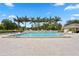 Relaxing pool area with palm trees, lounge chairs, and a building in the background at 3301 Bayshore Blvd # 2207B, Tampa, FL 33629