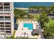 Aerial view of a pool, surrounded by lush landscaping and lounge chairs near a high-rise building at 3301 Bayshore Blvd # 2207B, Tampa, FL 33629