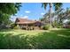 A grassy backyard with an enclosed pool, a brick patio and comfortable lounge seating at 3427 Forest Bridge Cir, Brandon, FL 33511