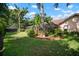 Lush backyard featuring a screened-in pool area, mature trees, and verdant landscaping that provide great privacy at 3427 Forest Bridge Cir, Brandon, FL 33511