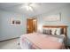 Bedroom with soft grey walls, wood trim, carpet, wooden bed frame, and light pink throw blanket at 3427 Forest Bridge Cir, Brandon, FL 33511