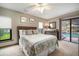 Bedroom features carpet, floral bedding, and sliding door to outdoor pool at 3427 Forest Bridge Cir, Brandon, FL 33511