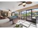 This enclosed patio features a pool, lounge seating, ceiling fan and billiard table at 3427 Forest Bridge Cir, Brandon, FL 33511