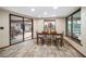 Bright dining area with wood floors, table with seating for six, and sliding doors to the patio at 3427 Forest Bridge Cir, Brandon, FL 33511