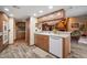 Cozy kitchen with wood cabinets, stainless steel oven, and views into the living room at 3427 Forest Bridge Cir, Brandon, FL 33511