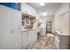 Laundry room with white cabinets, sink, washer, dryer, and wood-look tile flooring at 3427 Forest Bridge Cir, Brandon, FL 33511